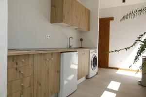 a kitchen with a sink and a washing machine at Casa Anahita in Lajares