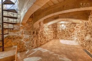 a room with a stone wall and a staircase at A 3BR characteristic home in Rabat with lovely views by 360 Estates in Rabat