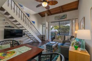 a living room with a couch and a table at Kailua Bay Resort 4-303 in Kailua-Kona