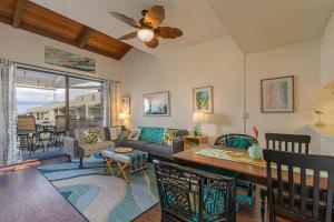 a living room with a couch and a table at Kailua Bay Resort 4-303 in Kailua-Kona