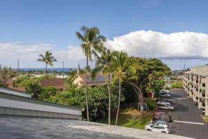 a view of a city with palm trees and a parking lot at Kailua Bay Resort 4-303 in Kailua-Kona