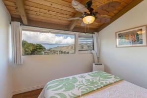 a bedroom with a ceiling fan and a window at Kailua Bay Resort 4-303 in Kailua-Kona +23 photos