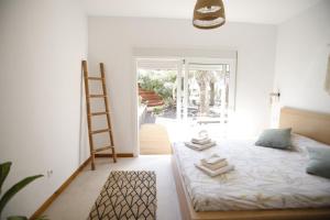 a bedroom with a bed and a ladder in it at Casa Anahita in Lajares