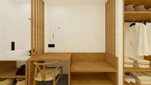 La salle de bains est pourvue d'un bureau en bois et d'un lavabo. dans l'établissement Pontikonisi Hotel & Suites, à Perama