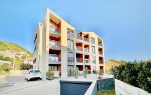 a car parked in front of a building at Fides Stylish Apartments Tivat with Pool in Tivat