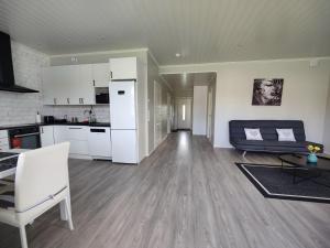 a kitchen and a living room with white appliances at ANDY - Perfect location in the heart of Närpes 75 m2 - Sauna - Built in 2023 in Närpiö
