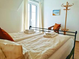 2 Betten in einem Zimmer mit Fenster in der Unterkunft Landhaus Vogel - helle und lichtdurchflutete Maisonette-Ferienwohnung in Wasserburg