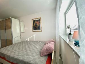 a small bedroom with a bed and a window at Ferienwohnung Riva - Wohlfühloase in ruhiger Lage in Lindau