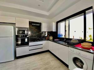 a kitchen with a washer and a dishwasher at Dar Selima by Amin BenSassi in Hammamet