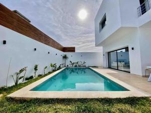 a swimming pool in the backyard of a house at Dar Selima by Amin BenSassi in Hammamet