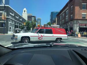 a red and white van driving down a city street at 2BR Hi-Rise Condo in Gaslamp SD in San Diego