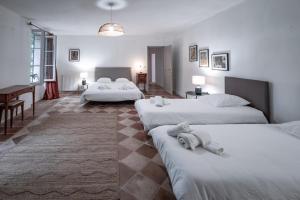 a hotel room with three beds and a piano at Gîte du chemin des Dames in Montauban