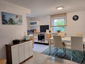 een keuken en eetkamer met een tafel en stoelen bij Schöni´s Zimmer in Abstatt