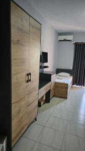 a room with a desk and a wooden door at Hotel Marigona in Shëngjin