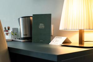 a book sitting on a table next to a lamp at Hotel Du Lac & SPA in Bellagio