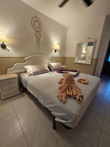 a bedroom with a large bed with towels on it at Casa Azul Montecastillo L7 in Caleta De Fuste +44 photos