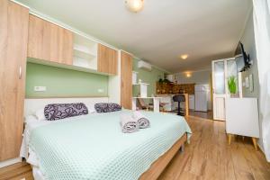 a bedroom with a bed with a white bedspread at Studio Leon & rent a quad in Mali Lošinj