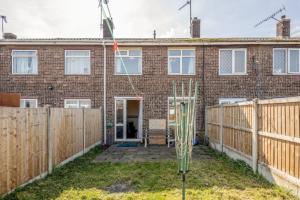 a brick house with a fence in front of it at Cosy 3 BDR Home With Wifi, Parking + Garden in Tilbury