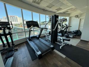 a gym with several tread machines in a building at REAL INN de Tijuana in Tijuana