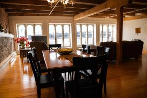 a dining room with a wooden table and chairs at Royal Dalhousie in Quebec City