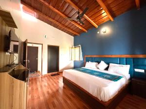 a bedroom with a bed and a flat screen tv at The little nest Home Stay in Bhīm Tāl