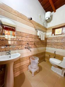 a bathroom with a sink and a toilet at The little nest Home Stay in Bhīm Tāl