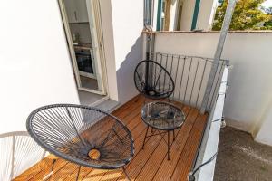 two metal chairs sitting on a wooden deck at *NEU* 2 Personen, WLAN, Balkon in Pirna