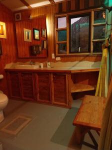 a bathroom with a sink and a toilet at Arte Vitral Lodge - 4camas- aislada- terrazas -vista - piscina-sauna in Guayacán