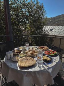 a table full of food on a white table cloth at Philia's Guest House in Sighnaghi