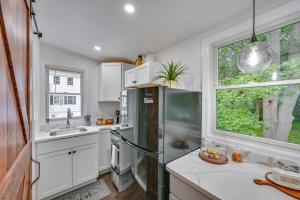 a kitchen with a refrigerator and a window at Charming Danvers Studio 5 Mi to Salem! in Danvers