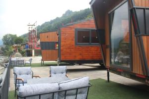 an rv with two chairs and a table and a table and chairs at Akasya Tiny House in Ardeşen