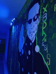 a painting of a man with glasses and a wall at Casa FedericaPet con piscina interna privata e riscaldata in Pagliare