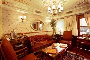 a living room with a couch and a table at Dersaadet Hotel Istanbul in Istanbul