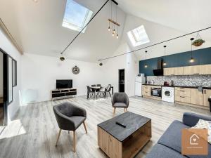 a living room with a couch and a table at Le Loft Climatisé - 6 personnes - Entrée autonome in Châtellerault +21 photos