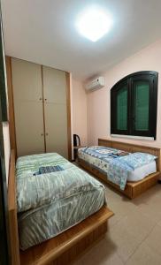 Giường trong phòng chung tại LA BOLINA LETOJANNI TAORMINA