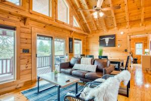 a living room with a couch and a table at Lakefront Cabin & Cozy Lakeview Cottage in Mills River