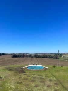 a small pool in the middle of a field at ROCCHETTA HOTEL BOUTIQUE in Sierra de los Padres