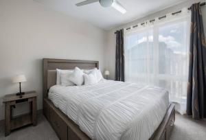 a bedroom with a large bed with a window at Fourth Street Crossing Traverse Townhome: Stylish Retreat in Silverthorne