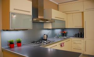a kitchen with white cabinets and a stove top oven at Spacious apartment in the heart of Krakow in Krakow