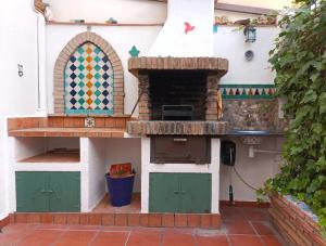 un modèle de cuisine avec un four à pizza dans l'établissement Casa de la Portuguesa, bonita terraza con barbacoa, à Güéjar-Sierra