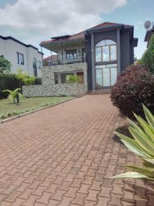 a brick driveway in front of a house at Kagarama Residential House: in Kigali