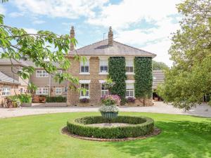 a large house with a fountain in the middle of a yard at Harford House in York