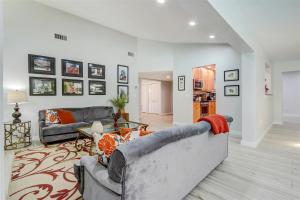 a living room with a couch and a table at Lakefront, Pool, outdoor kitchen, lush garden in Naples