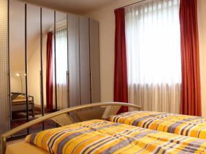 a bedroom with two beds and a mirror at Ferienwohnung Panorama pur in Lindau