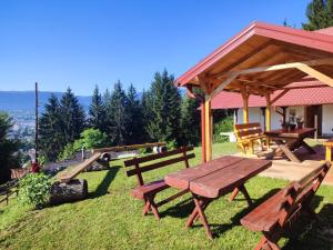 a picnic table and a gazebo in a park at Vila Starcevic in Pale
