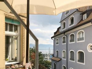 a view of the ocean from the balcony of a house at Ferienwohnung am Segelhafen - Altstadtperle direkt am Segelhafen in Lindau