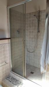 a shower with a glass door in a bathroom at Wilsons in Torriana