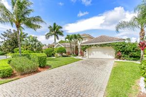 a house with palm trees and a driveway at Modern home w screened pool, hot tub, & comm amenities! in Naples