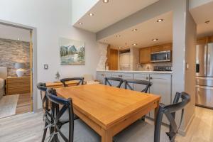 a kitchen and dining room with a wooden table and chairs at Lake Forest Lakeview Long Stay Condo: Fantastic Location, Views in Frisco