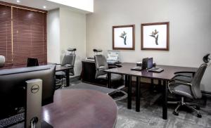 an office with two desks and chairs and a table at Southern Sun Ridgeway Lusaka in Lusaka